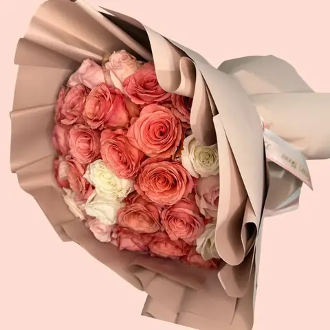 Coral Chic Bouquet - Standard - 48-50 roses Deluxe - 73-75 roses Premium- 99-100 roses A sophisticated arrangement featuring roses in coral, ivory, and soft blush tones. Each bloom is carefully selected to create a harmonious design that evokes sweetness, romance, and elegance. Perfect for special moments or simply to say “you’re on my mind.
