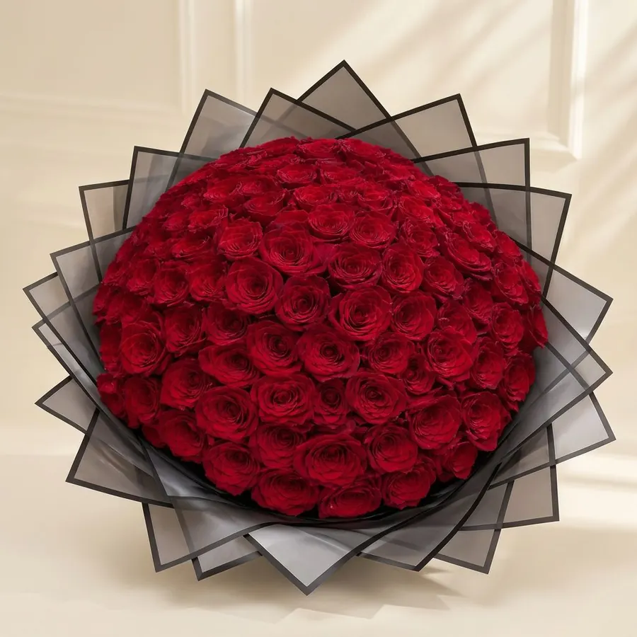 Round bouquet of deep red roses in black organza wrapping