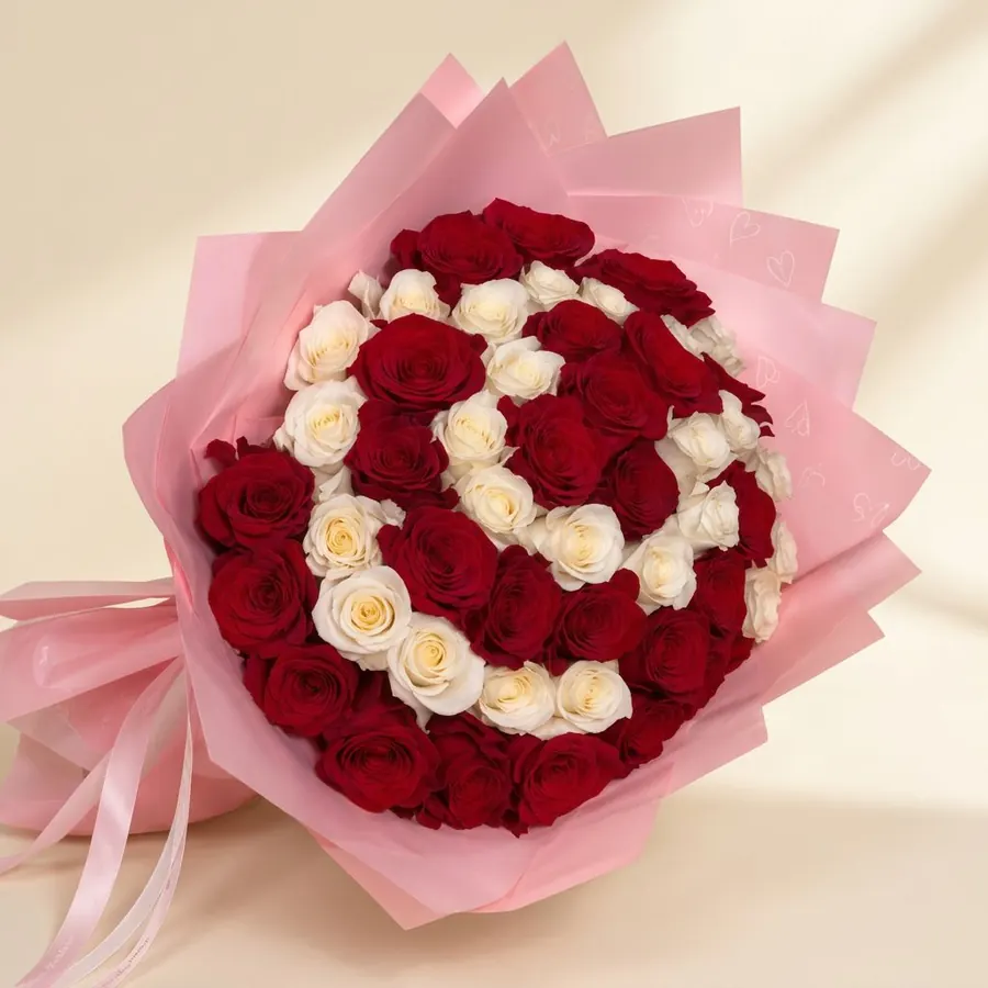 Red and cream rose bouquet in blush heart-print wrapping